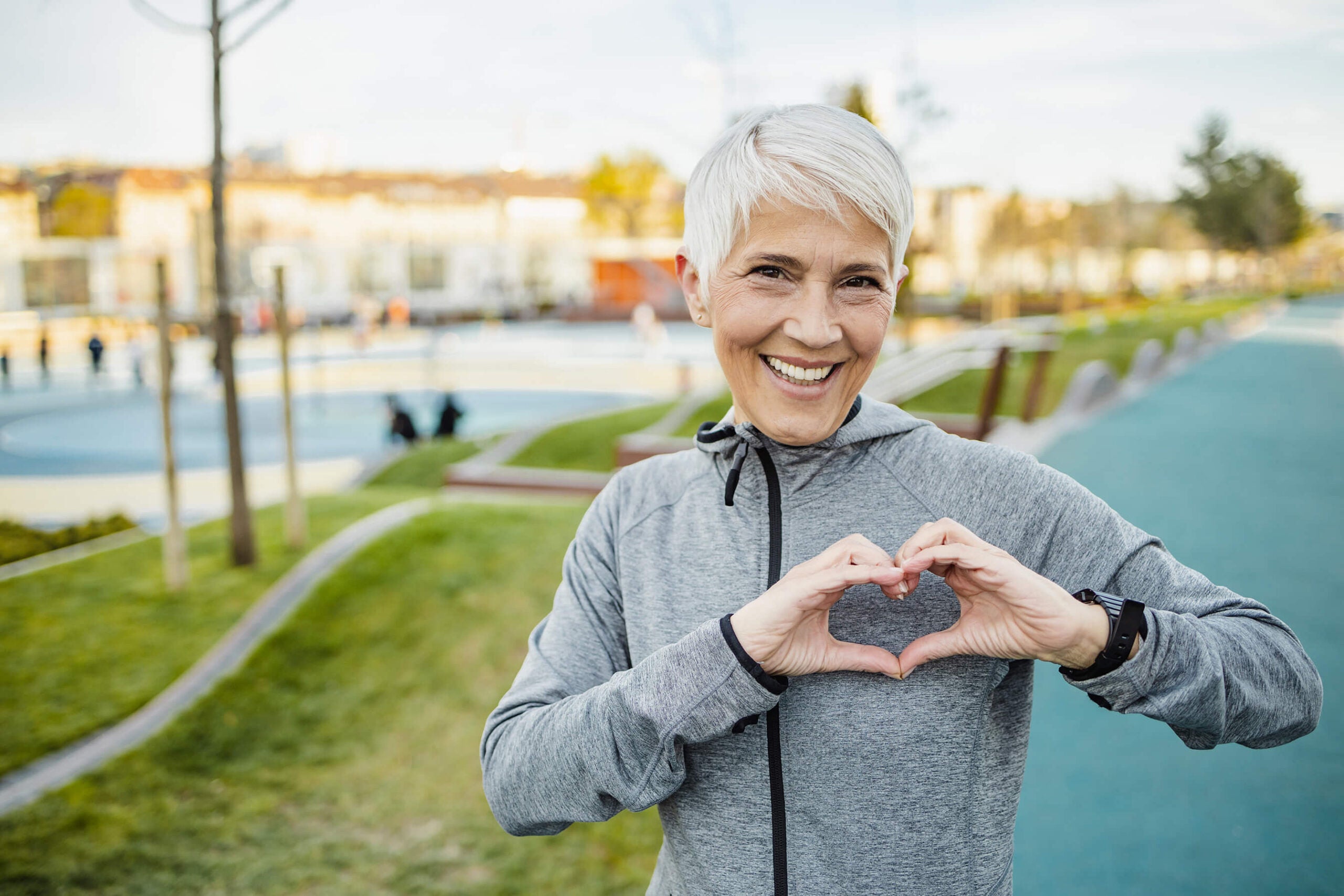 Exercising woman making a heart symbol
