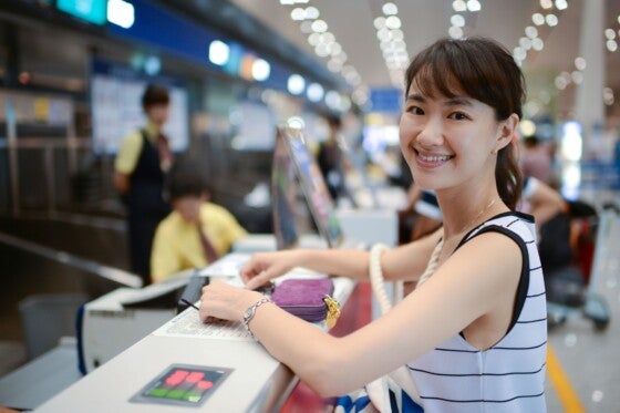 Female Passenger At Airport Ticket Counter