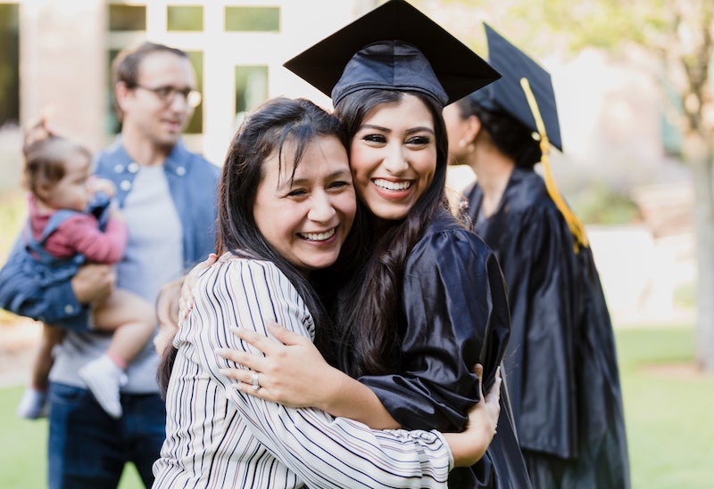 Mother hugging daughter at graduation