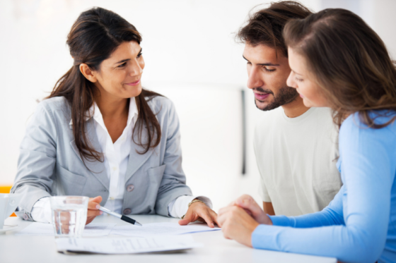 Couple meeting with lender and using land as collateral for a loan.