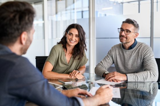 Couple meeting with lender to discuss loan structure.