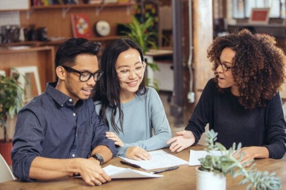 Small business owner couple discussing the down payment on a commercial property with lender.