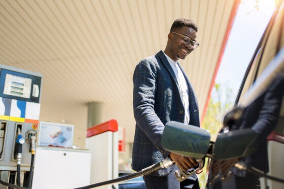 man filling up car with gas