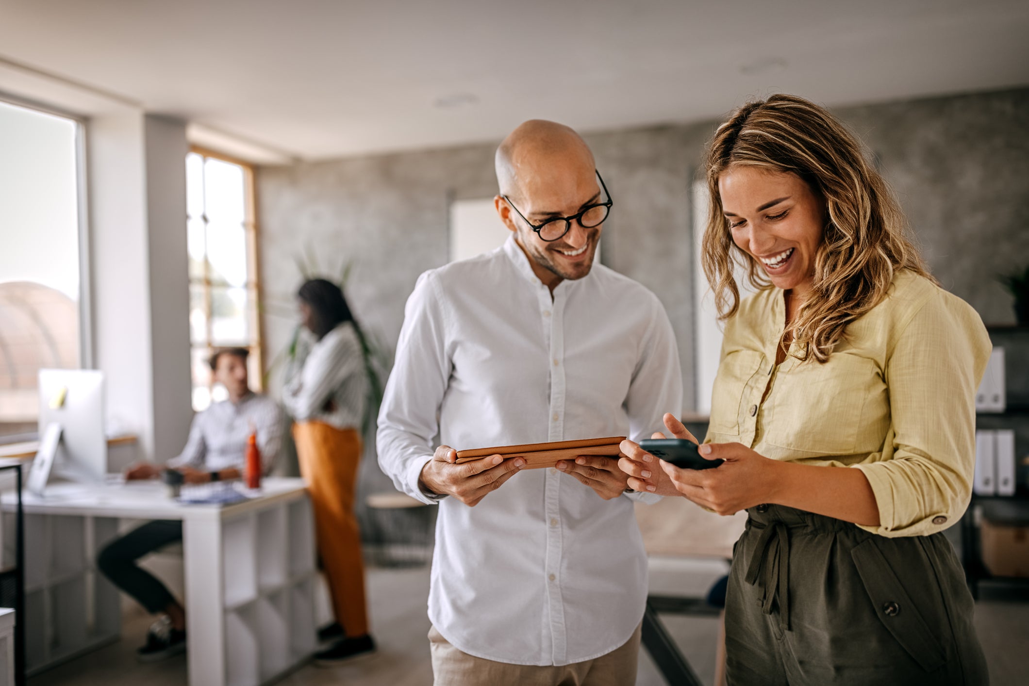 two business owners looking at business checking account happy