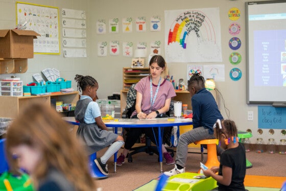 Students sitting with teacher learning at Chattanooga Micro school.