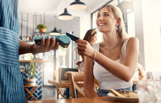 college student using her tap top pay debit card to earn rewards for buying lunch