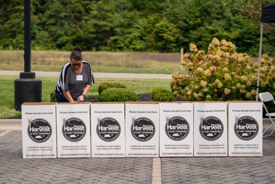 SouthEast Bank BSA Officer Bonnie Swearingen putting donations in second harvest boxes during food drive event at SouthEast Bank.