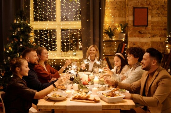 Family celebrating with sparklers over holiday meal