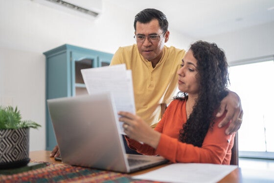 Couple doing home finances using laptop