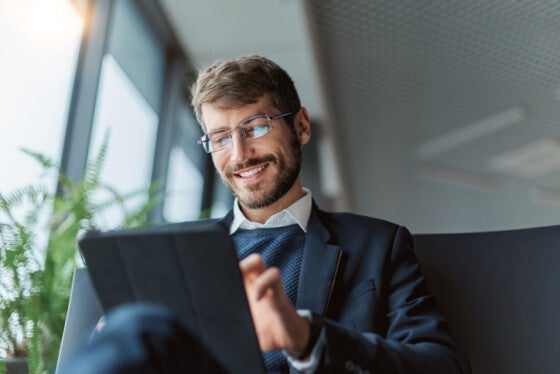 man checking bank account on tablet