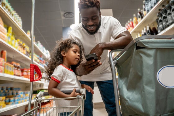 Man and daughter grocery shopping