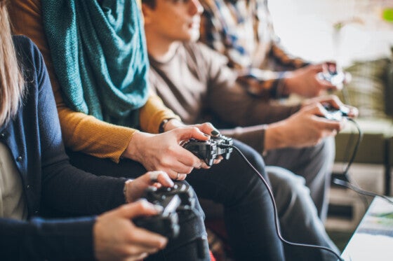 Group of friends playing video games at home