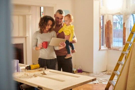 Family looking at tablet amid house renovations