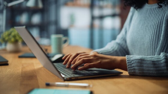 Close Up on Hands of a Female Specialist Working on Laptop