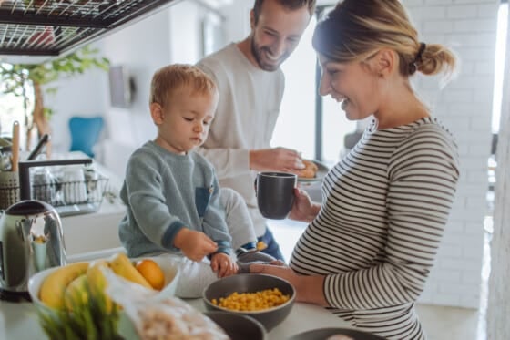 Photo of a young family preparing breakfast together in their kitchen