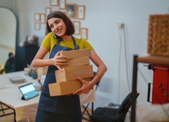 Young female entrepreneur runs an online business from her ceramics studio.